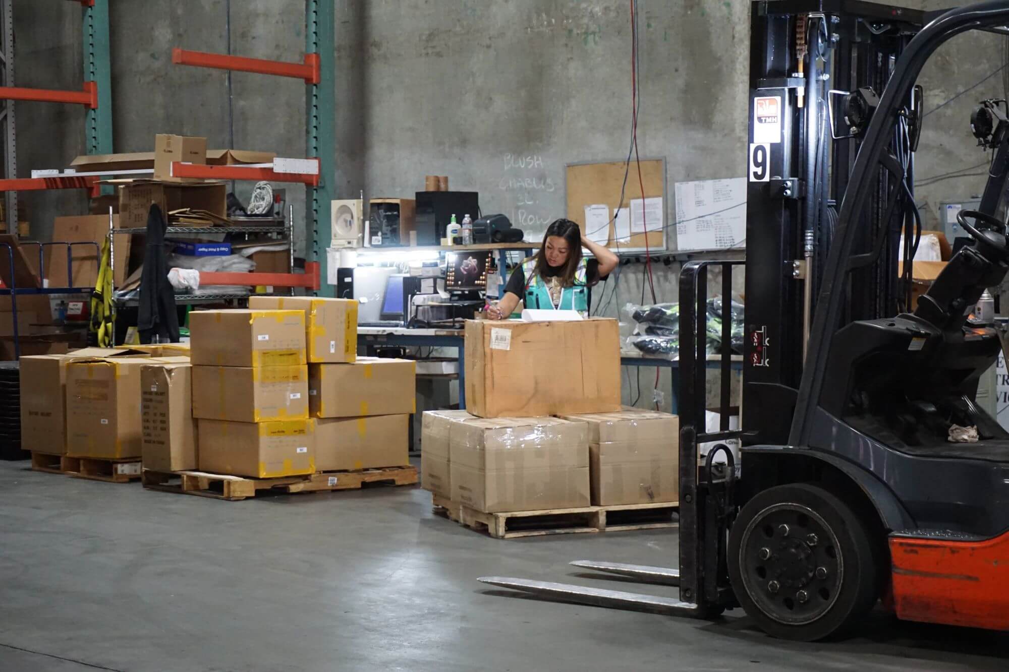 Woman managing order fulfillment at San Jose Distribution Services